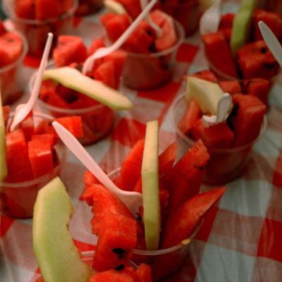 photograph of rows of watermelon in plastic cups at New York City street fair